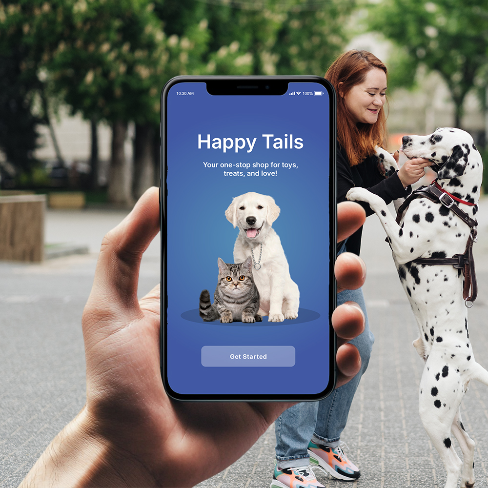 Happy Tails app open on a phone, held up beside a person playing with a dalmatian on a street